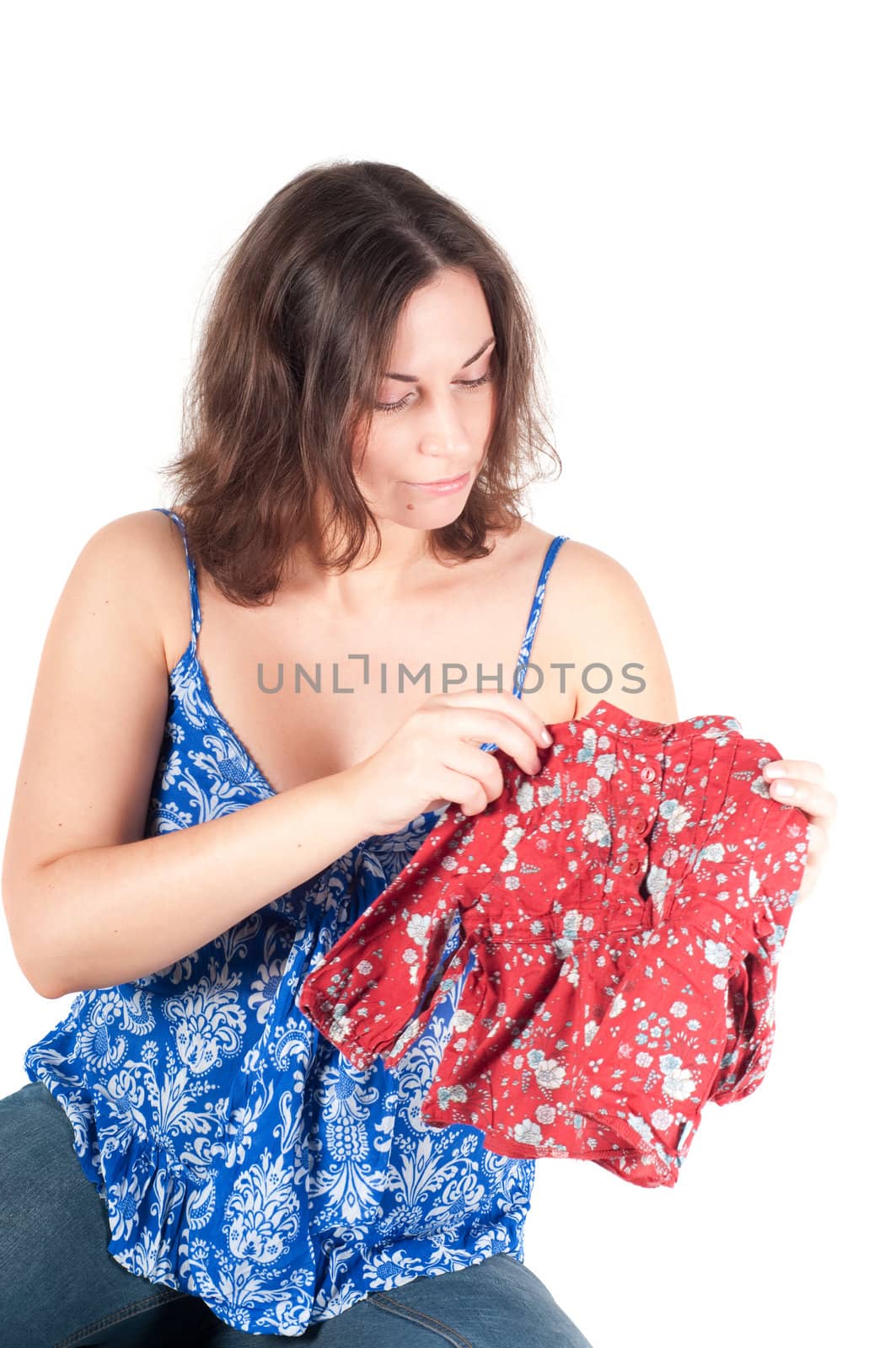 Portrait of pretty pregnant woman with baby clothes isolated on white