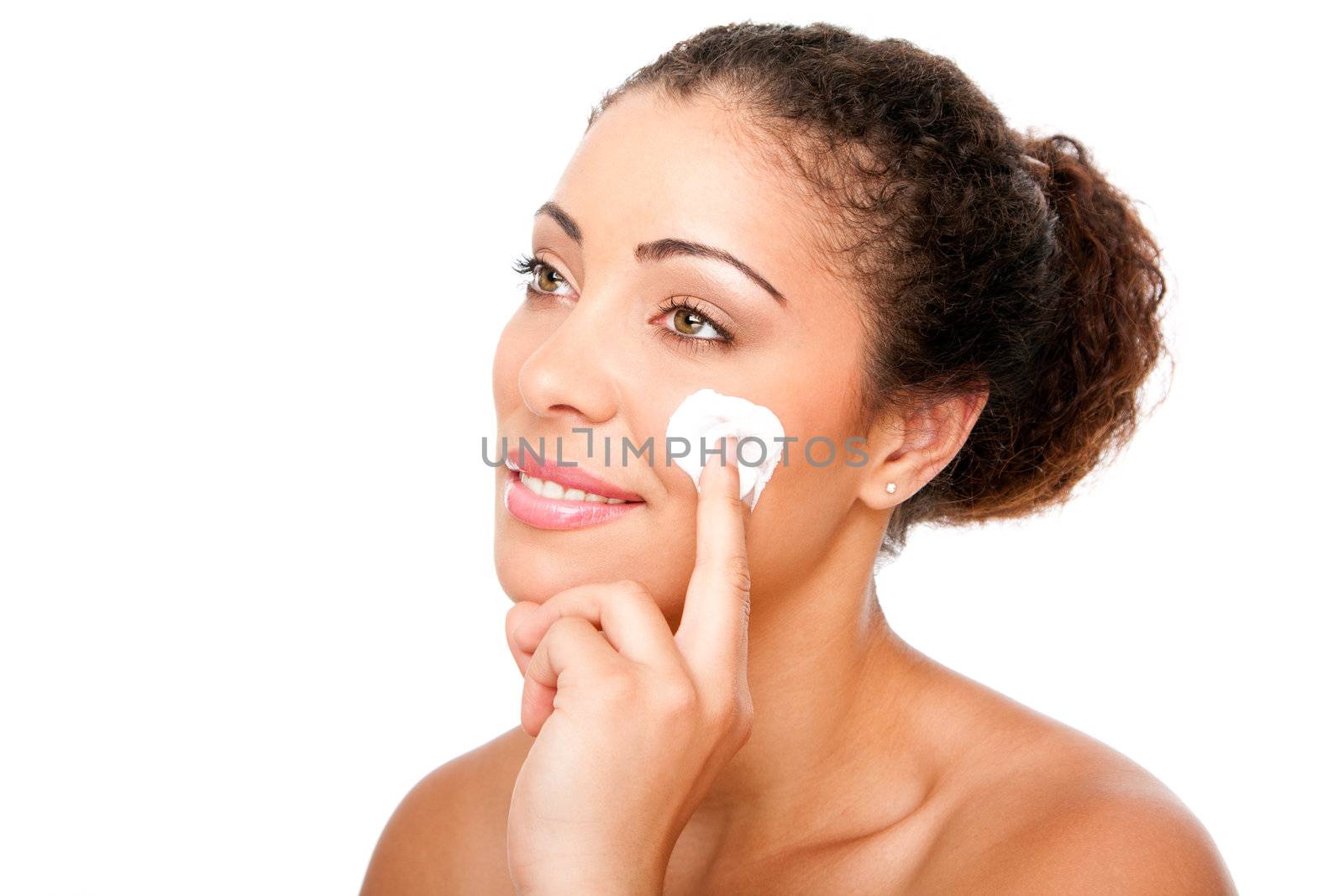 Beautiful face of young woman with hand applying exfoliating anti wrinkle cream beauty treatment for skincare, isolated.