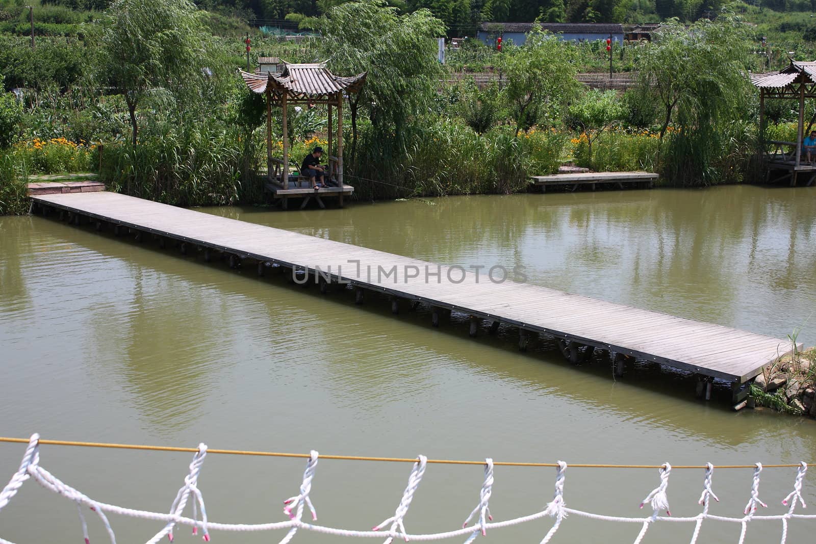 Wooden bridge over the water by limengdi