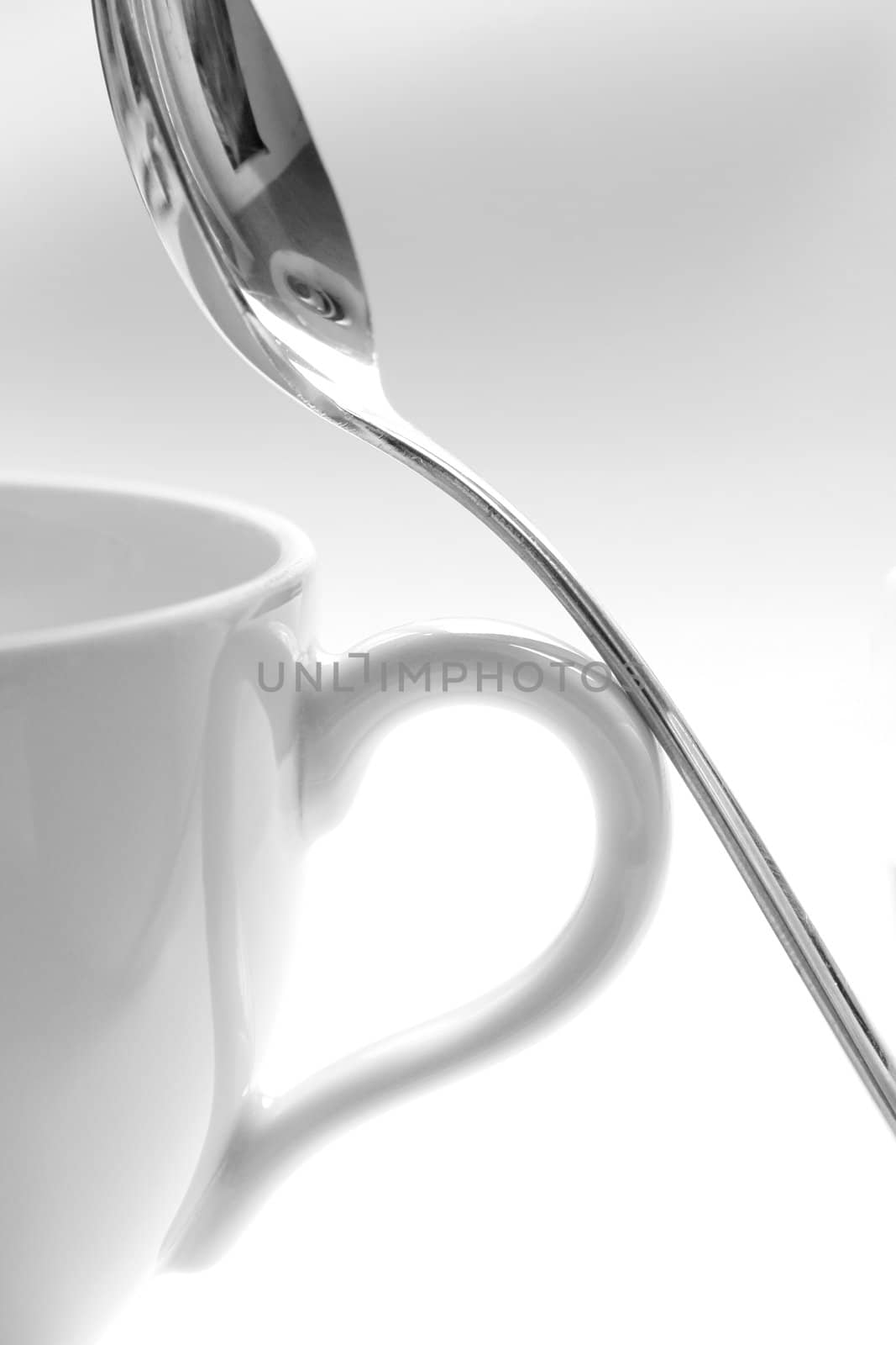 A cup and a spoon on a white background