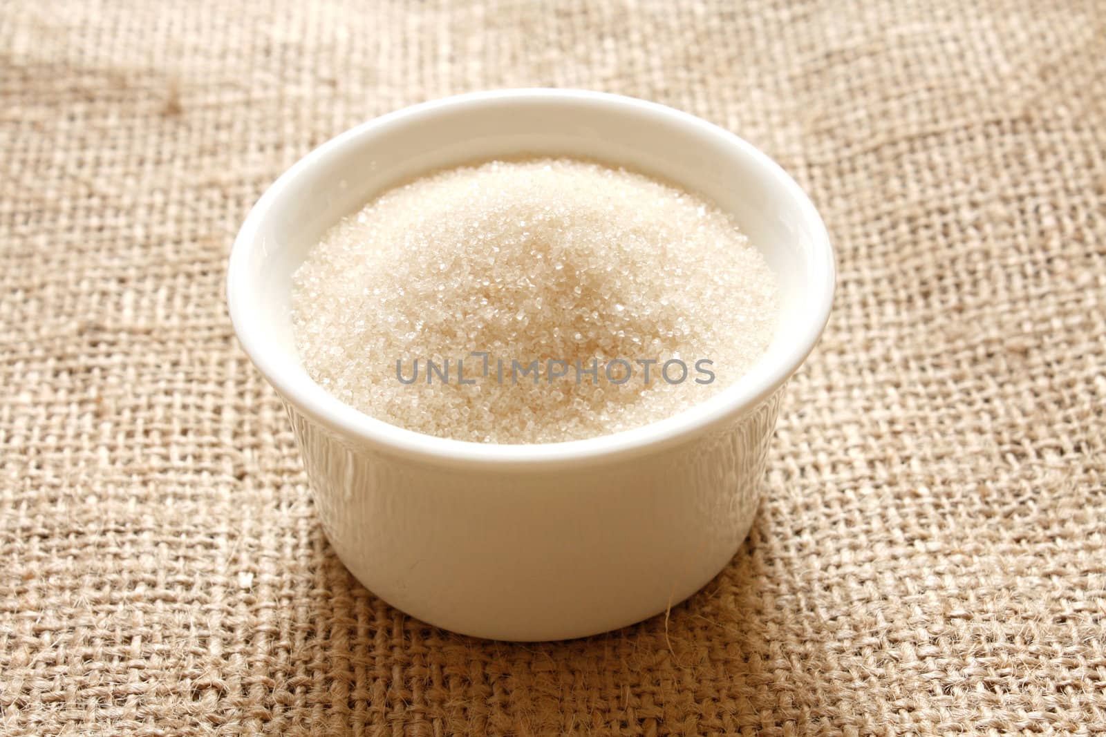 Cane sugar in a bowl on a background