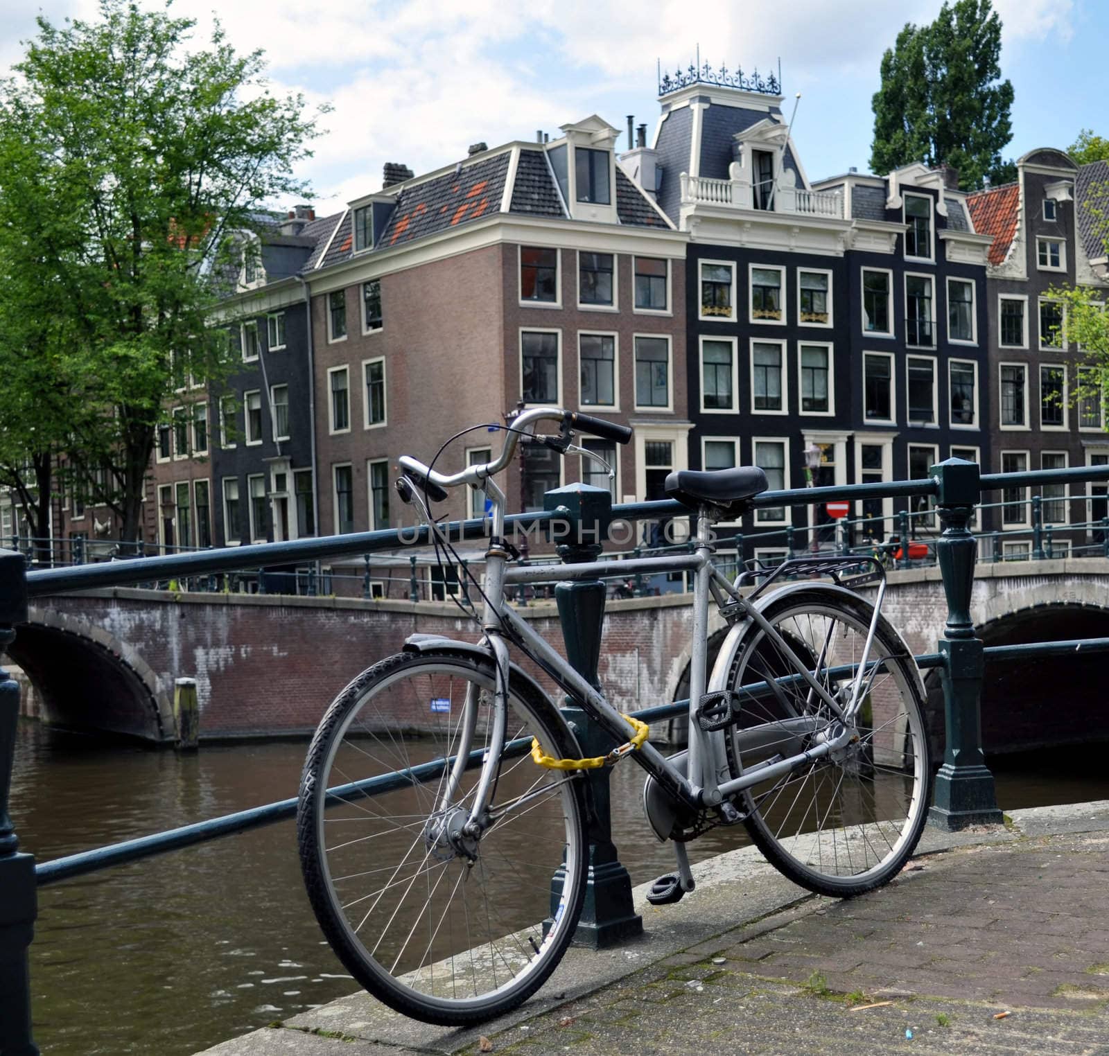 Bicycle parked on a bridge in Amsterdam