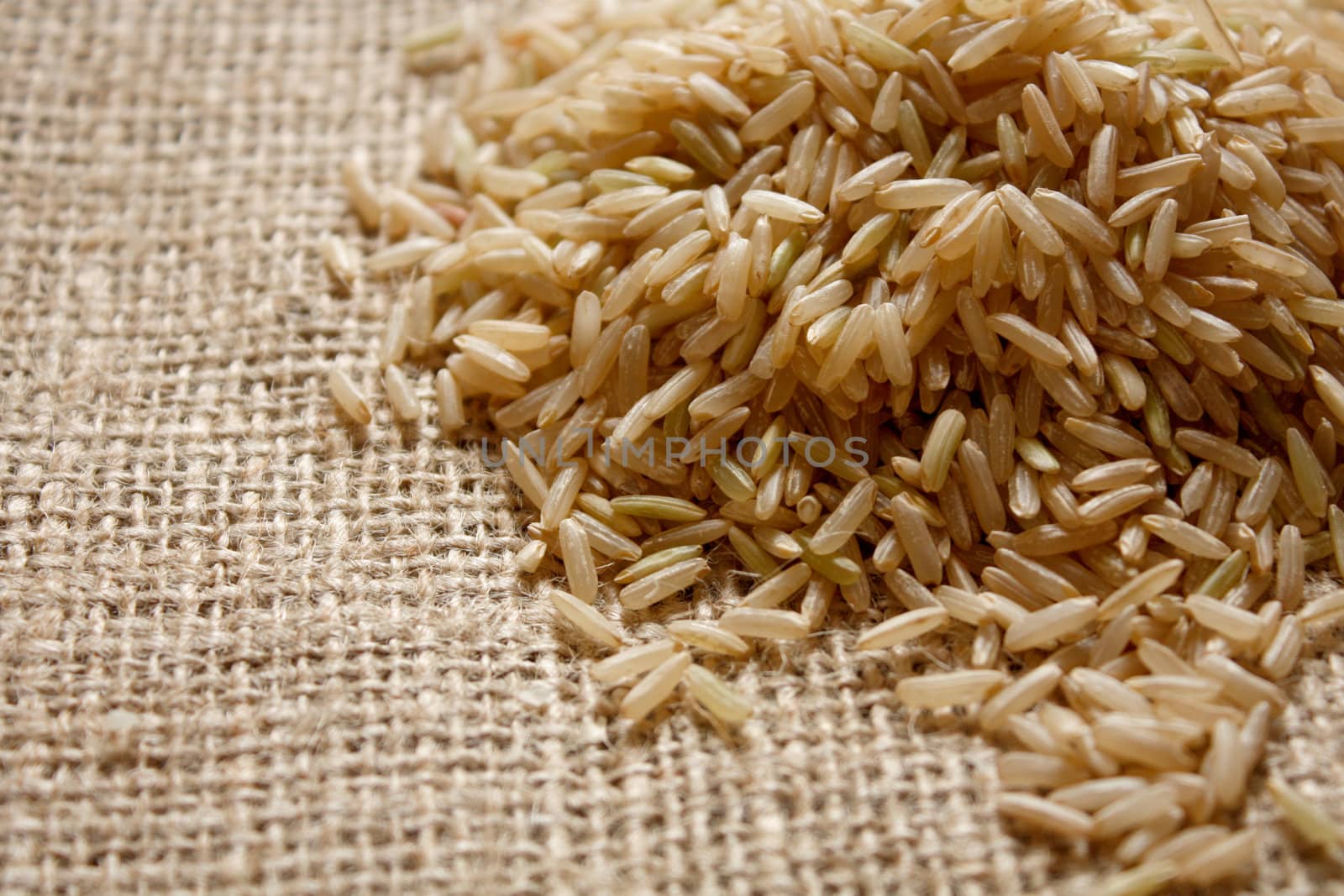 Brown rice on a textile background