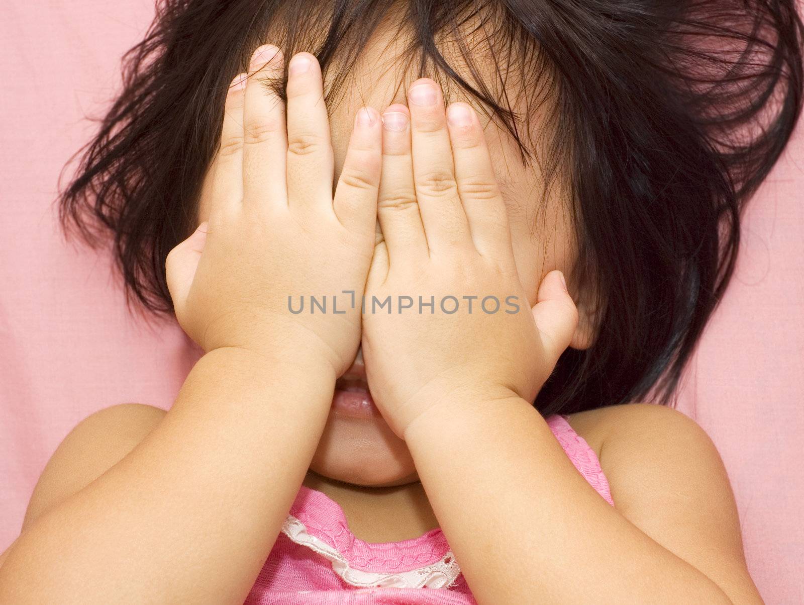 little girl playing peek-a-boo.