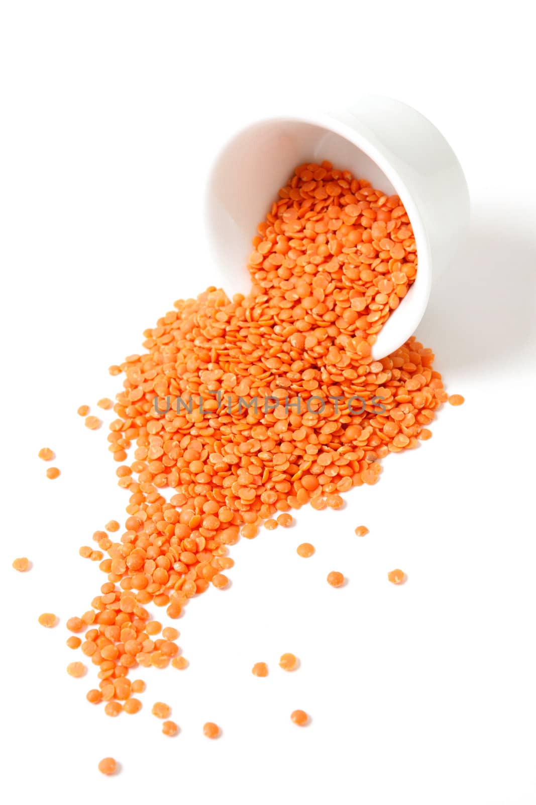 Red lentils on a white bg