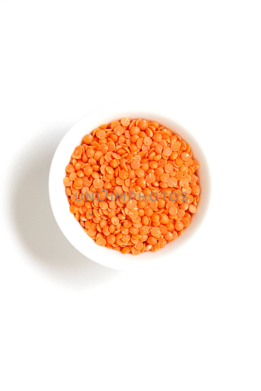 Red lentils on a white bg