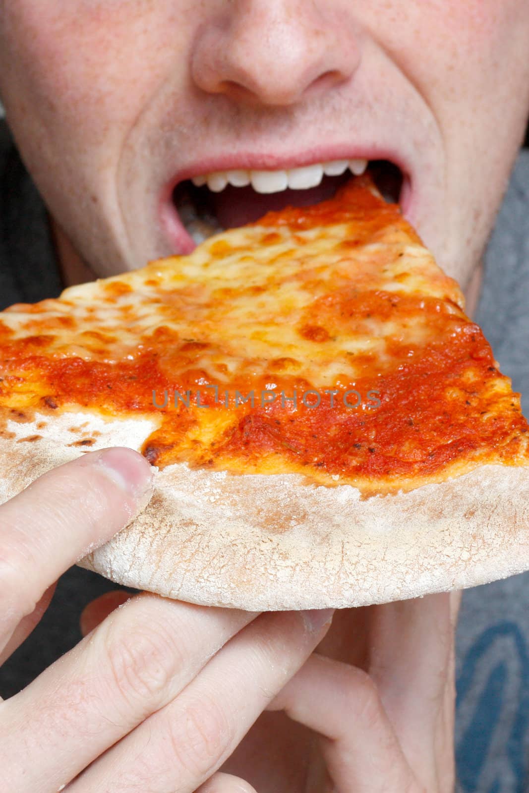 Man eating a pizza slice