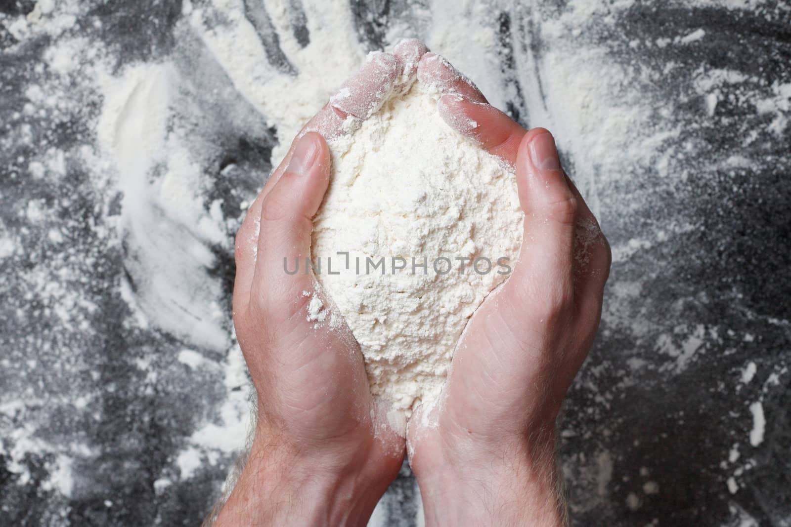 Hands holding white wheat flour