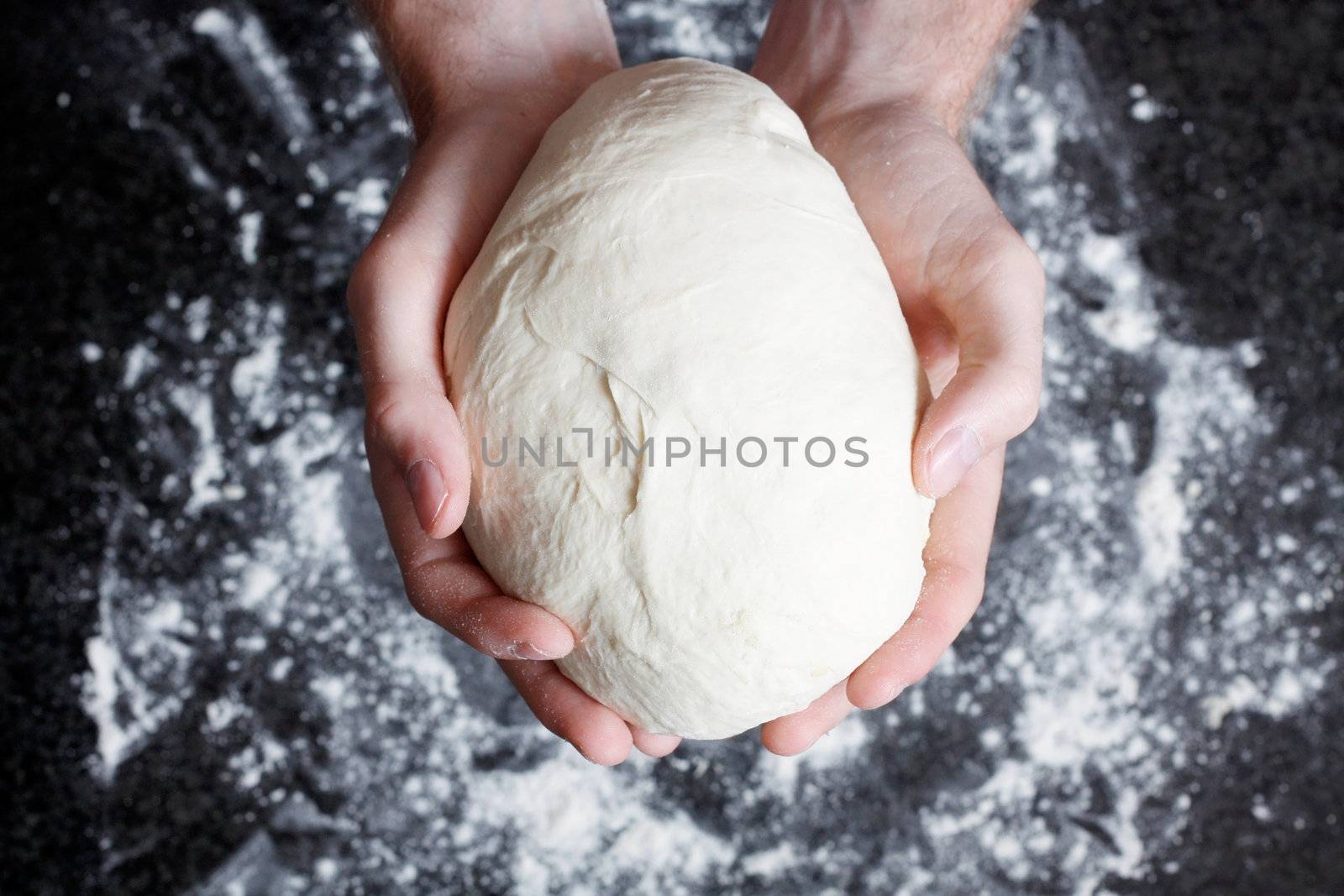 Hands holding a finished clean dough