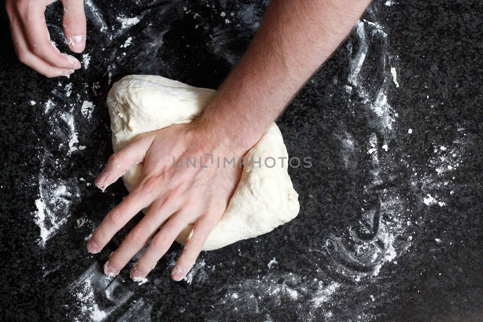 Hands kneading a dough