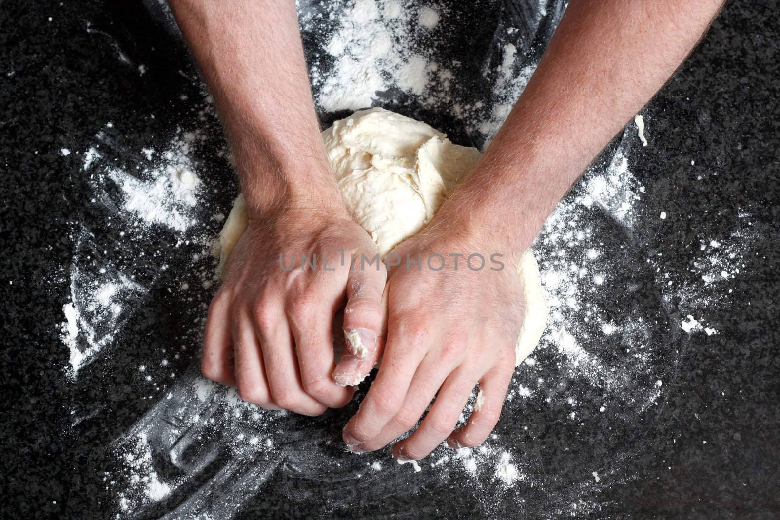 Hands kneading a dough