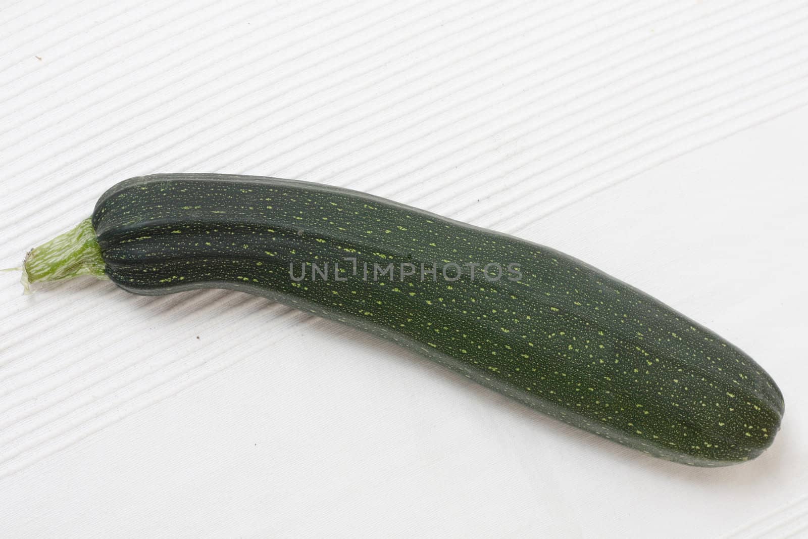 An organic zucchini on a white background