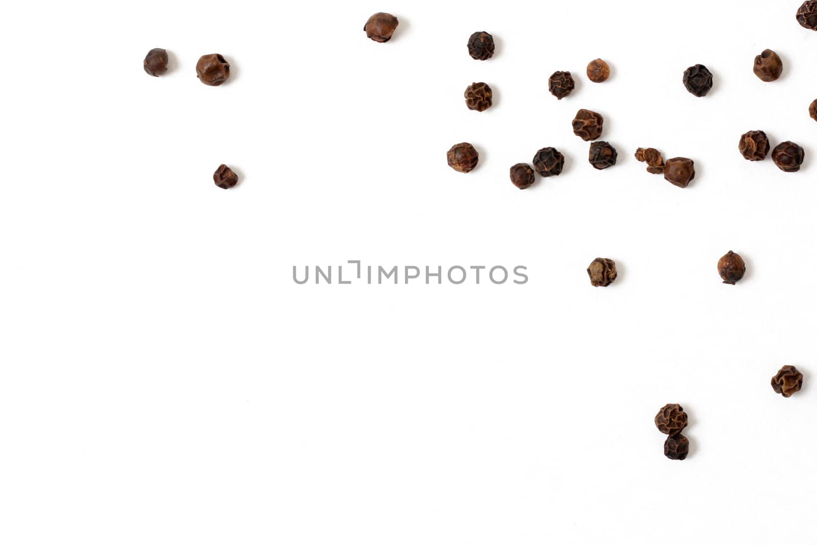 Wholesome peppercorns on a white bg