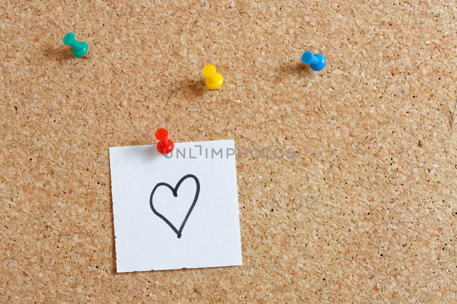 Pins on a wooden notice board