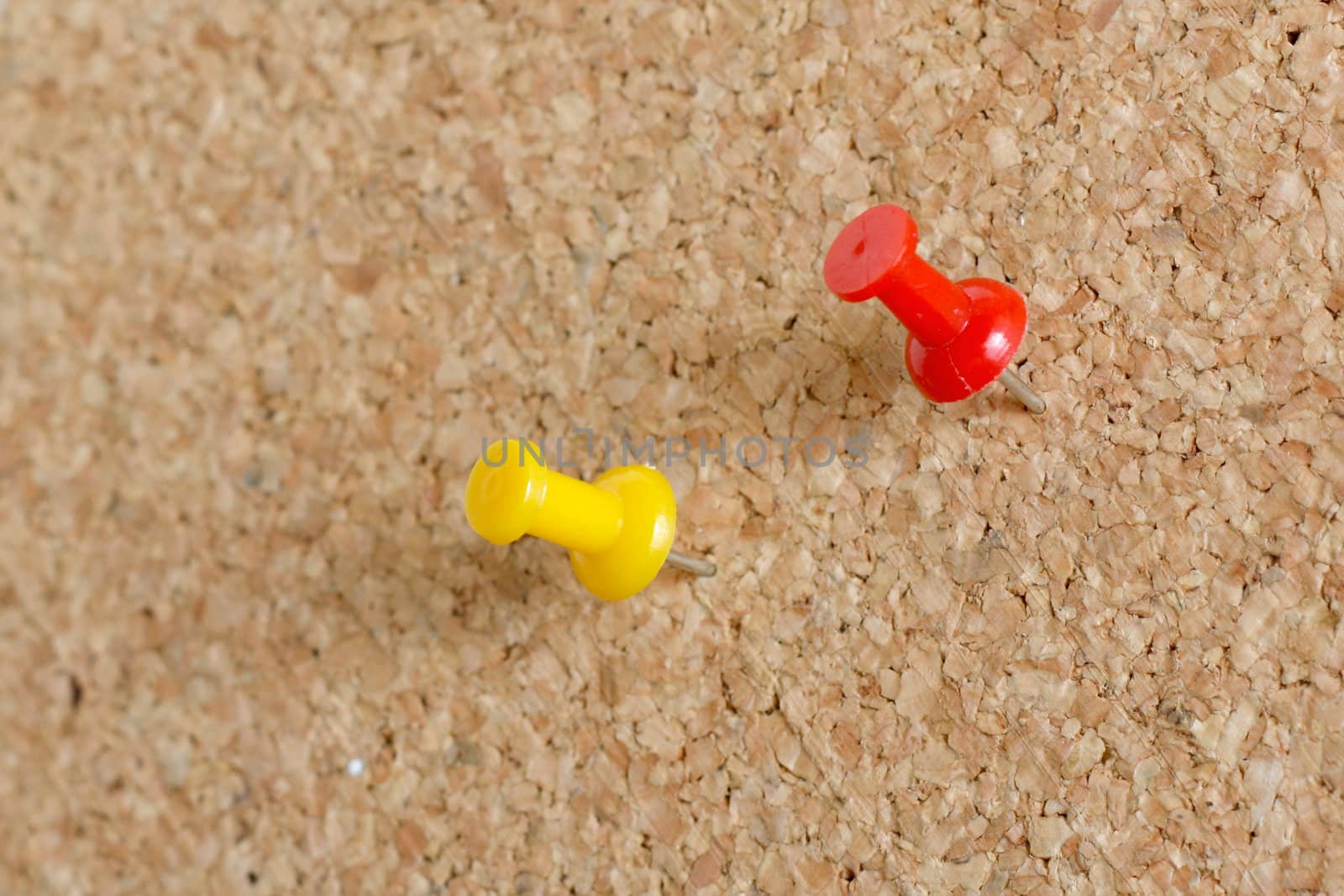 Pins on a wooden notice board