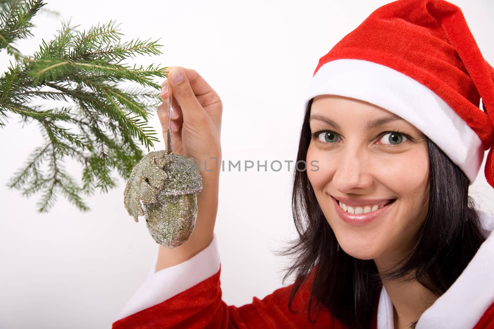 Santa Claus girl hanging toy on christmas tree
