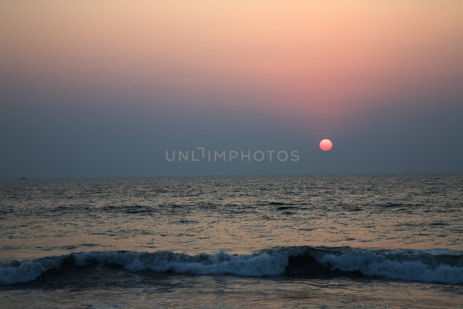 Sunset in the Arabian sea in Goa over blue sky
