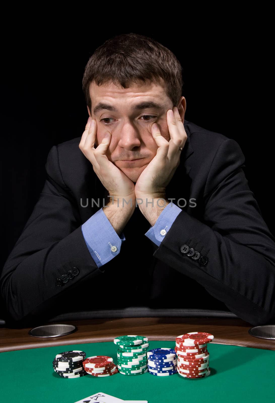 Stylish man in doubt before making bet in the casino