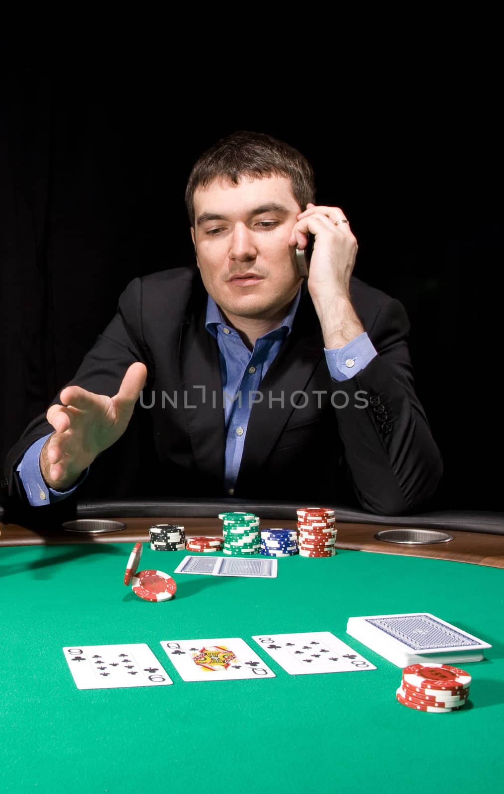 Attractive young caucasian man make bet in the casino