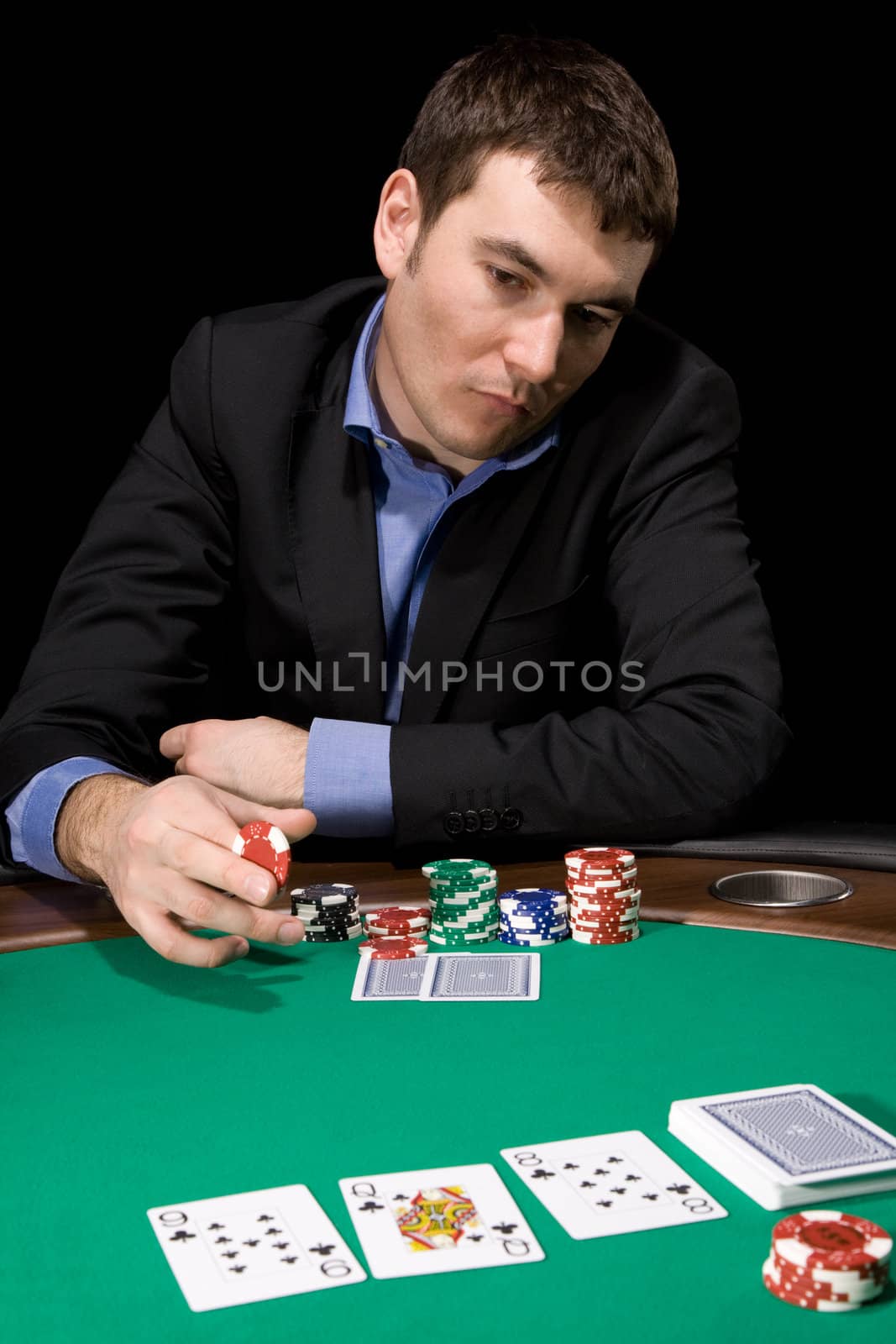 Stylish man in doubt before making bet in the casino