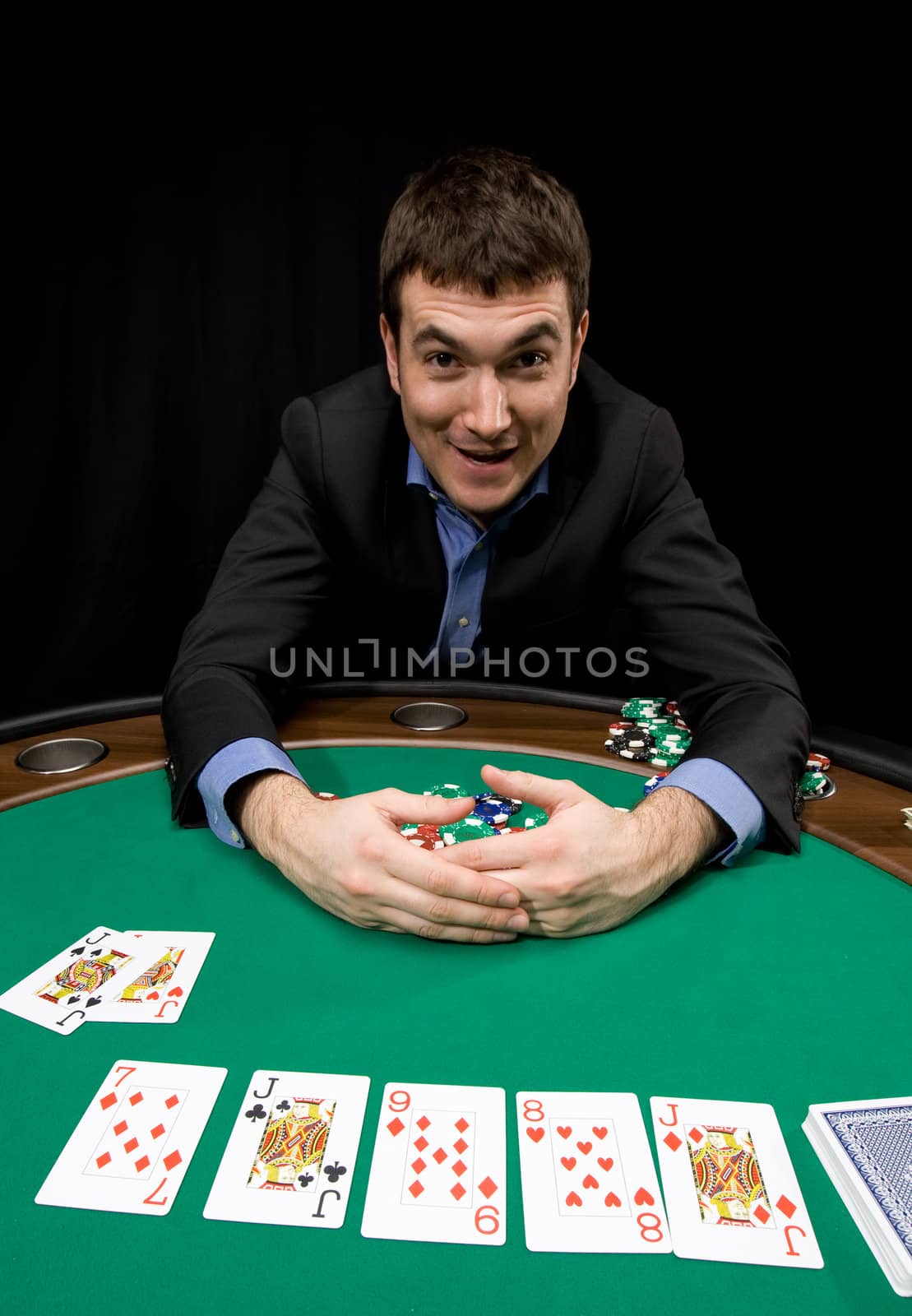 Caucasian man win with four of a kind in casino poker