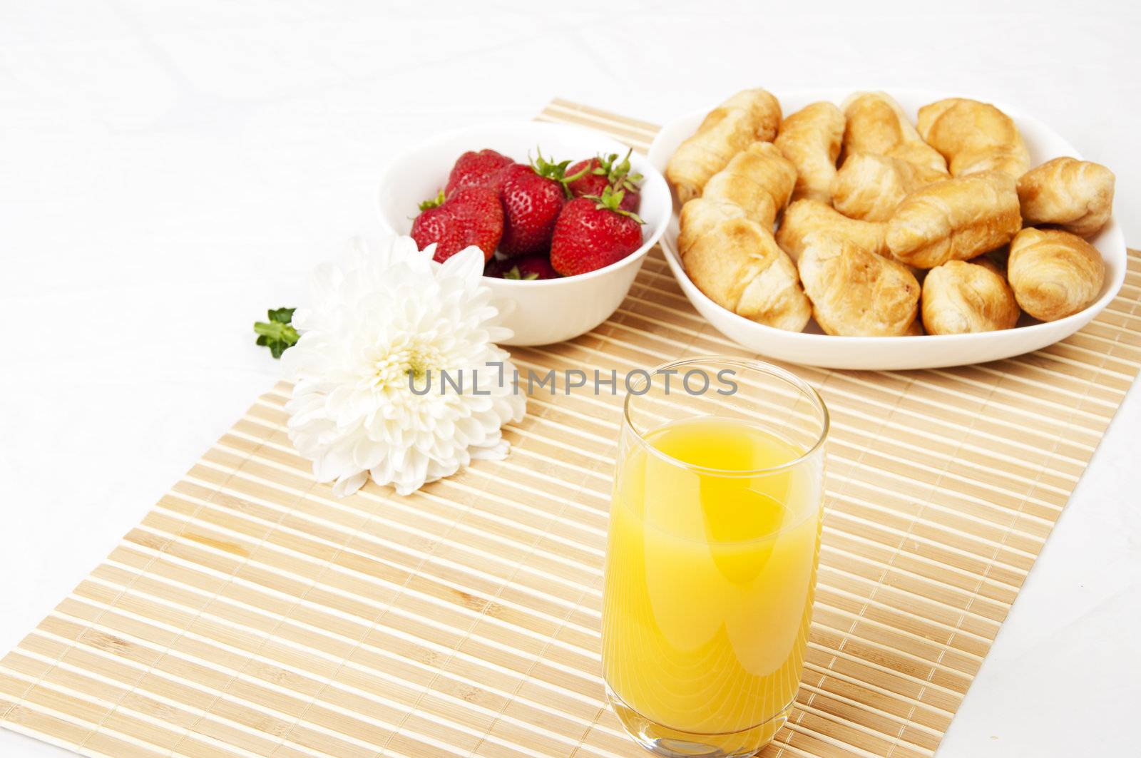 juice, croissants and Berries On a bamboo napkin by adam121