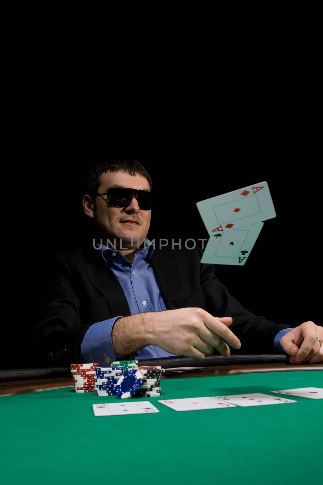 Flying cards in texas hold'em poker over green casino table
