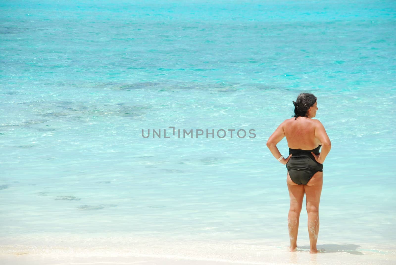senior woman looking at a tropical beach in Maldives