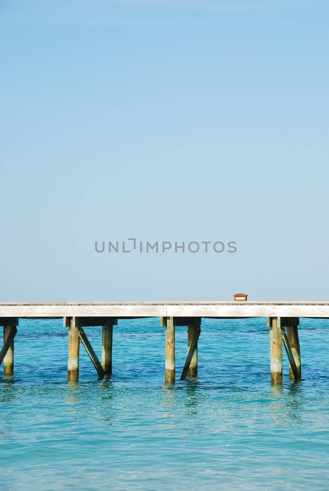 Wooden jetty bridge on a beautiful Maldivian beach by luissantos84
