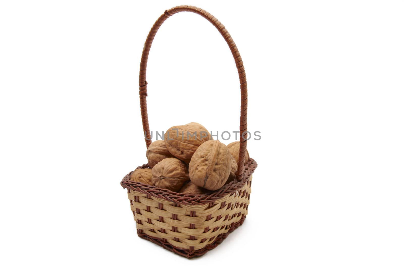 Walnuts in wicker basket isolated on white background