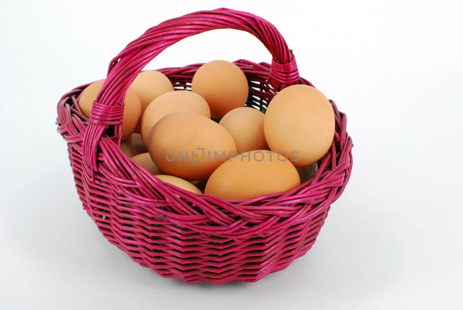 basket with eggs on white