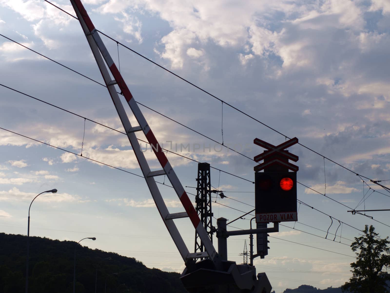 the rail crossing with crossbar and the traffic lights