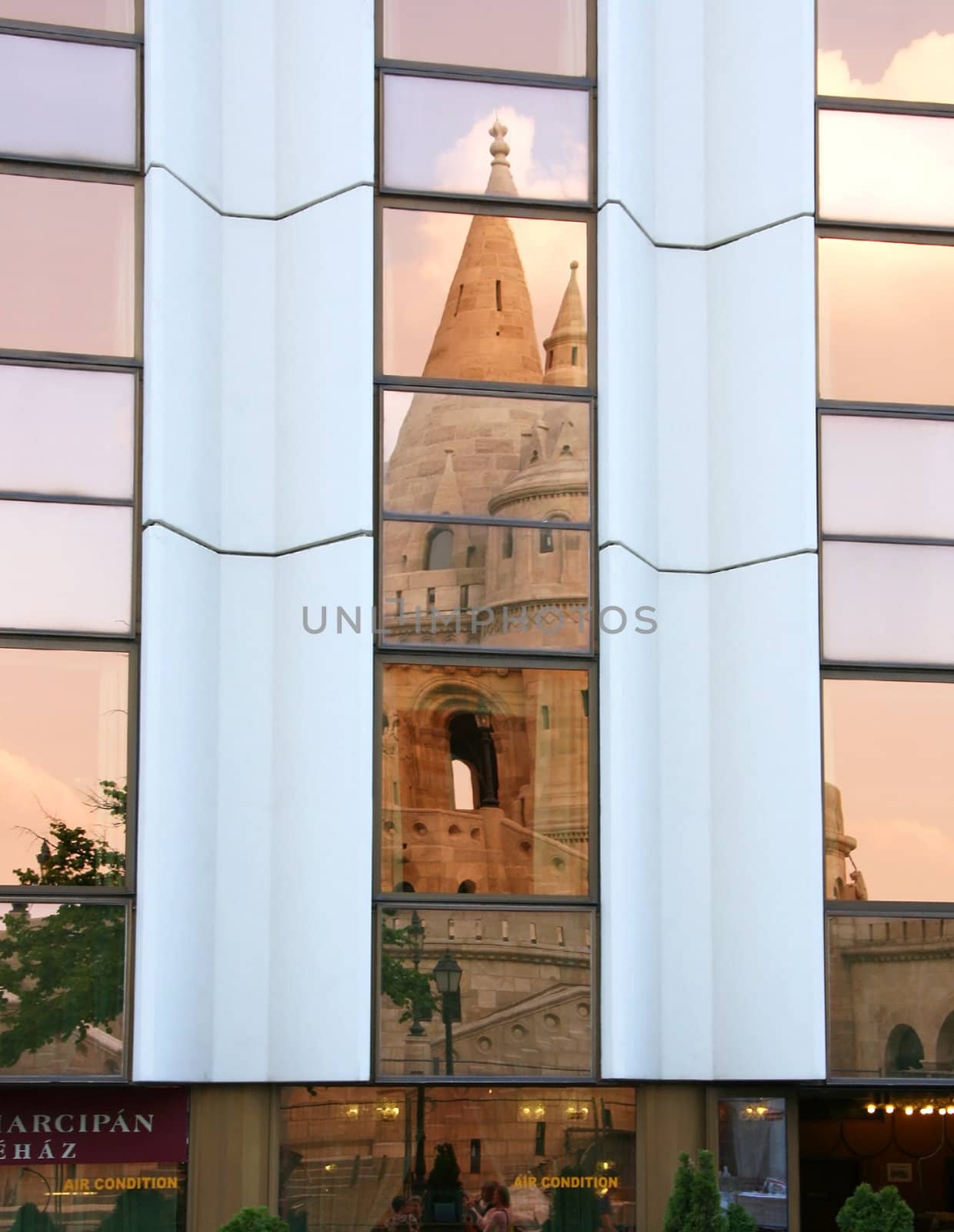 Show Fishermen's Bastion in front of a mirror of modern building