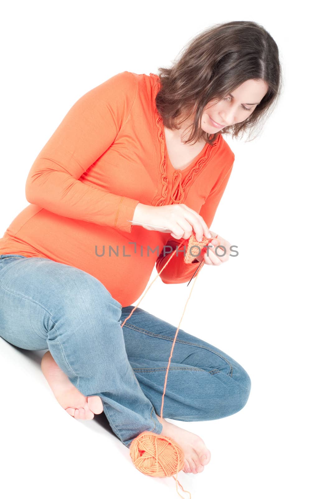 Portrait of pretty pregnant woman knitting by anytka