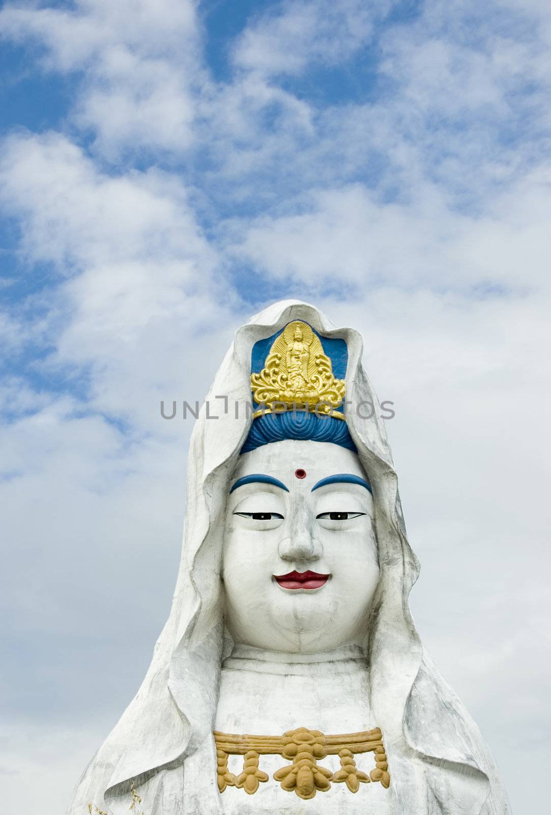 Guanyin statue with a white clouds background 