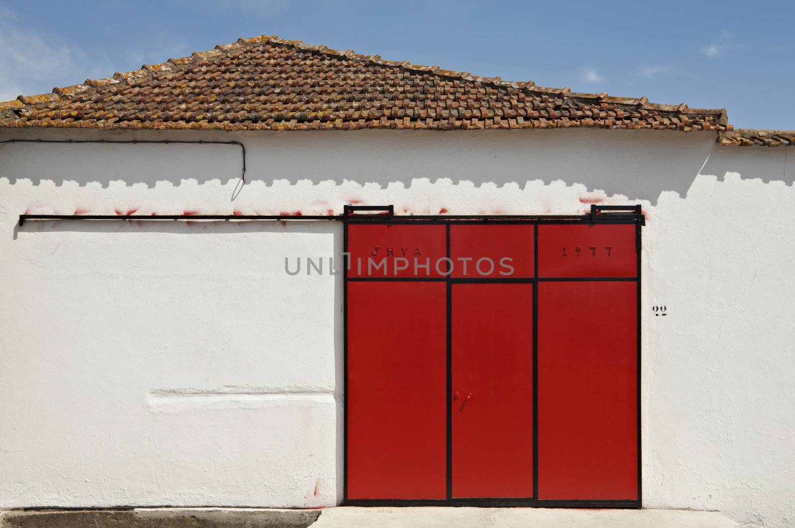 Red sliding gate in a warehouse, Portugal