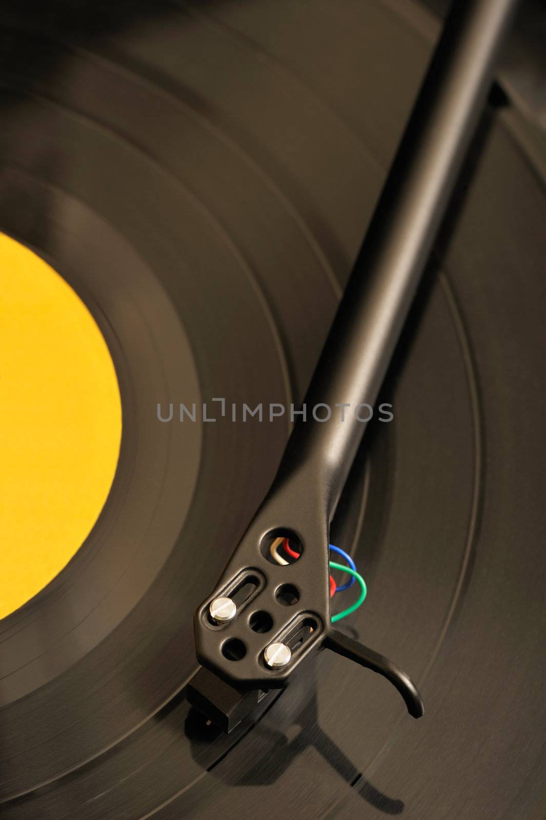 Close-up image of a turntable playing a record with a yellow label