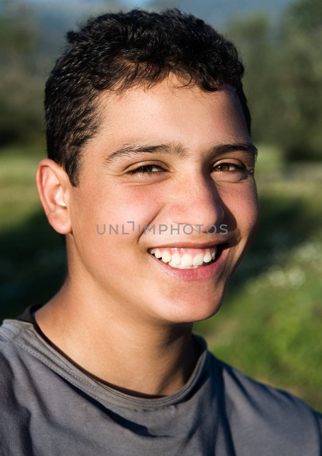 Portrait of a young guy smiling in rural setting