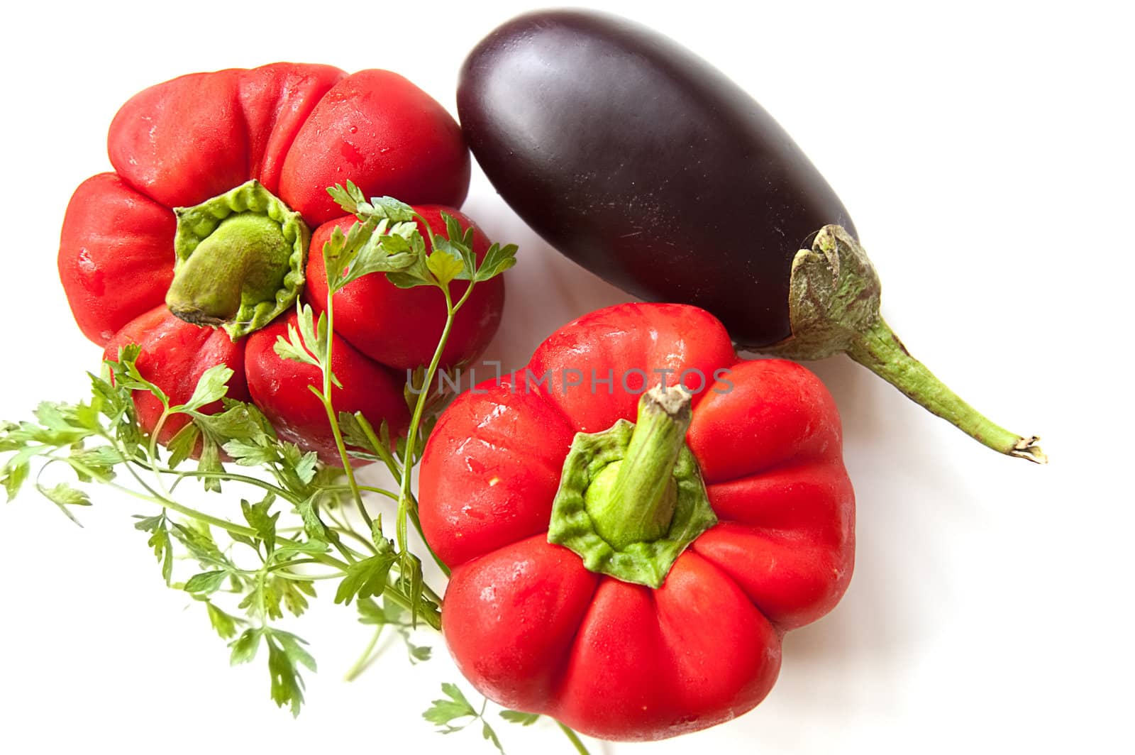 Aubergine, red pepper and greens over white