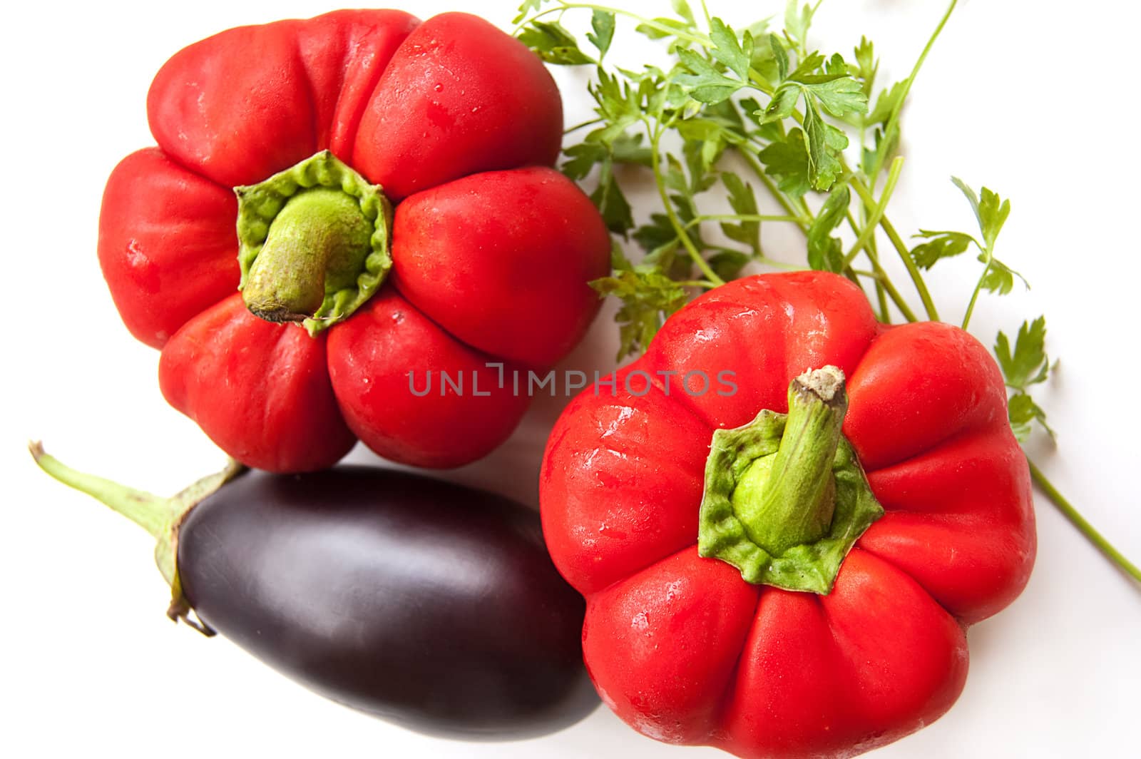 Aubergine, red peppers and greens over white