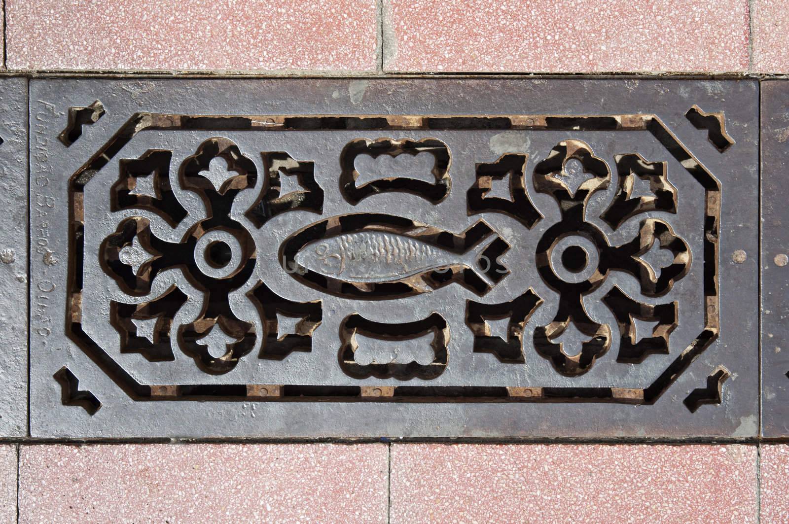 Decorated sewer grate in a street of Vila Real de Santo Antonio, Algarve, Portugal