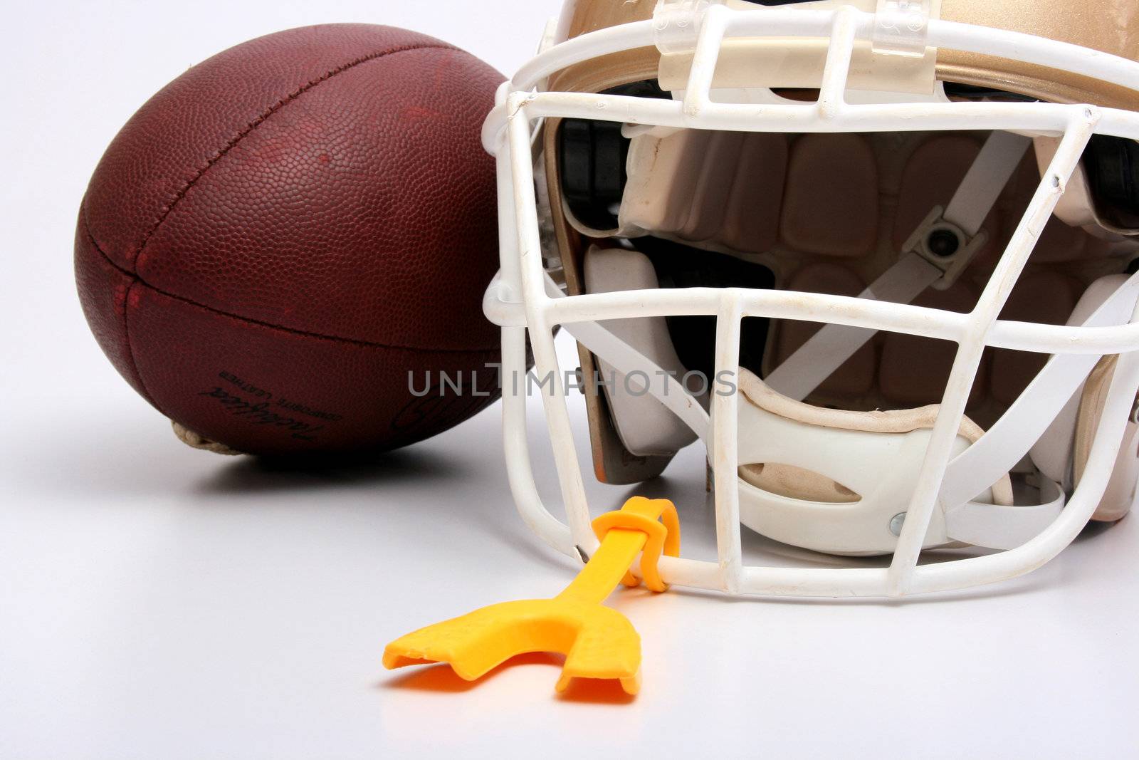 Helmet and ball for game in the American football with a mouthpiece.