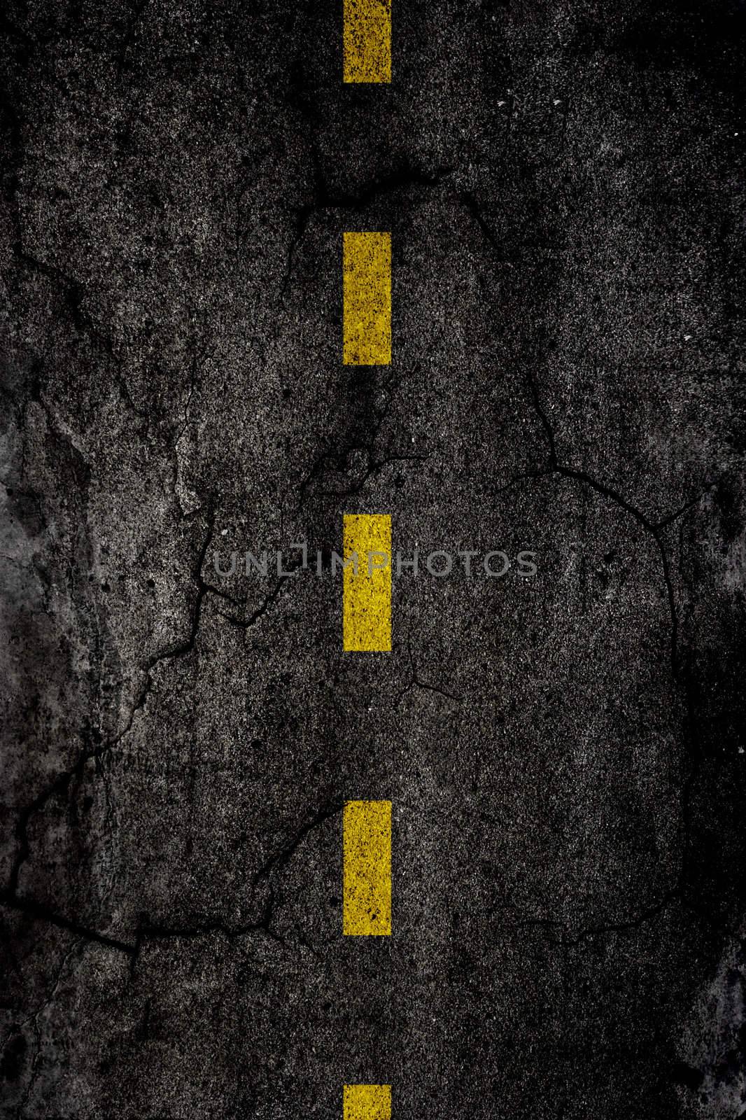 
Asphalt background texture with a divided yellow line