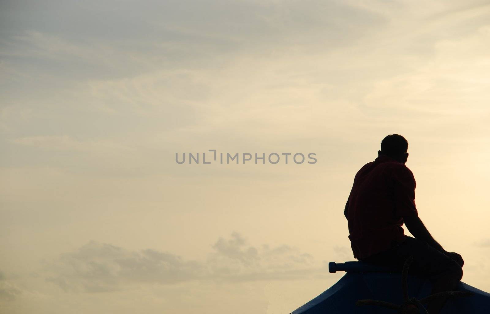 beautiful silhouette of a fisherman and dhoni fishing boat in Maldives during sunset