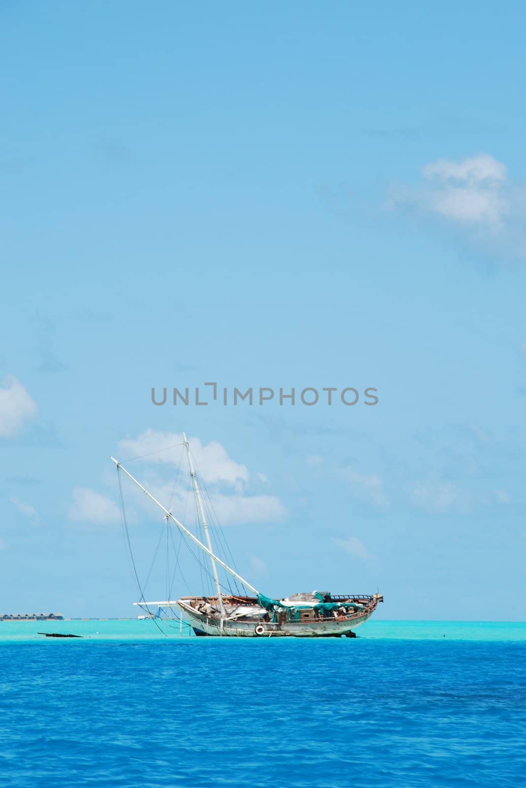 Semi-submerged typical ship on Maldives by luissantos84