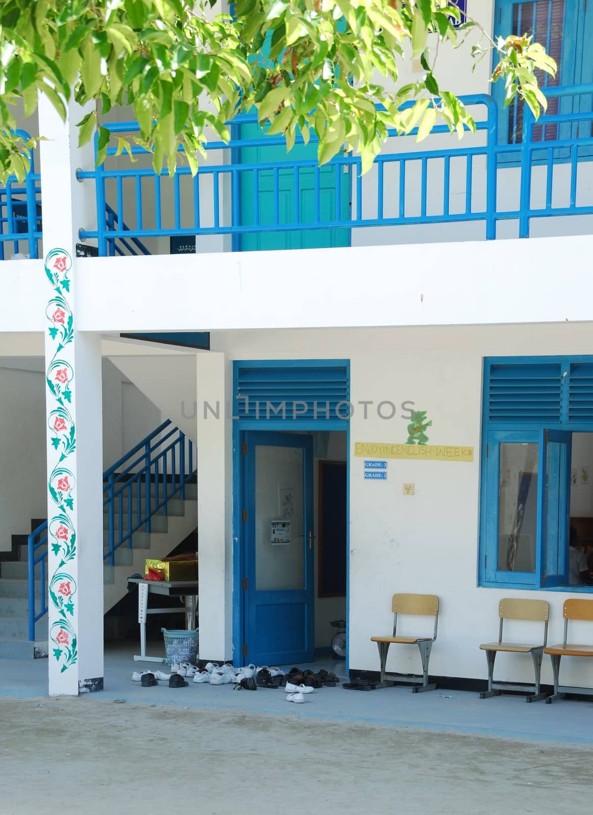 Blue Maldivian school with trainers outside by luissantos84