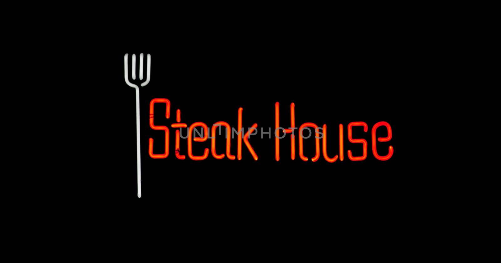 White and red steak house neon on black background