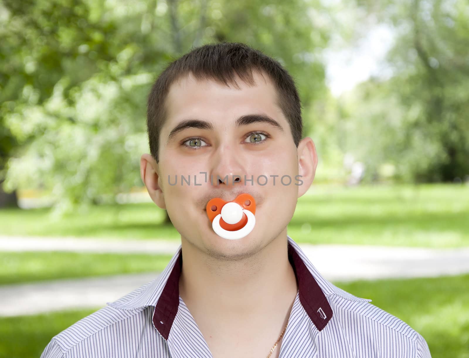 The man holds a dummy in a mouth