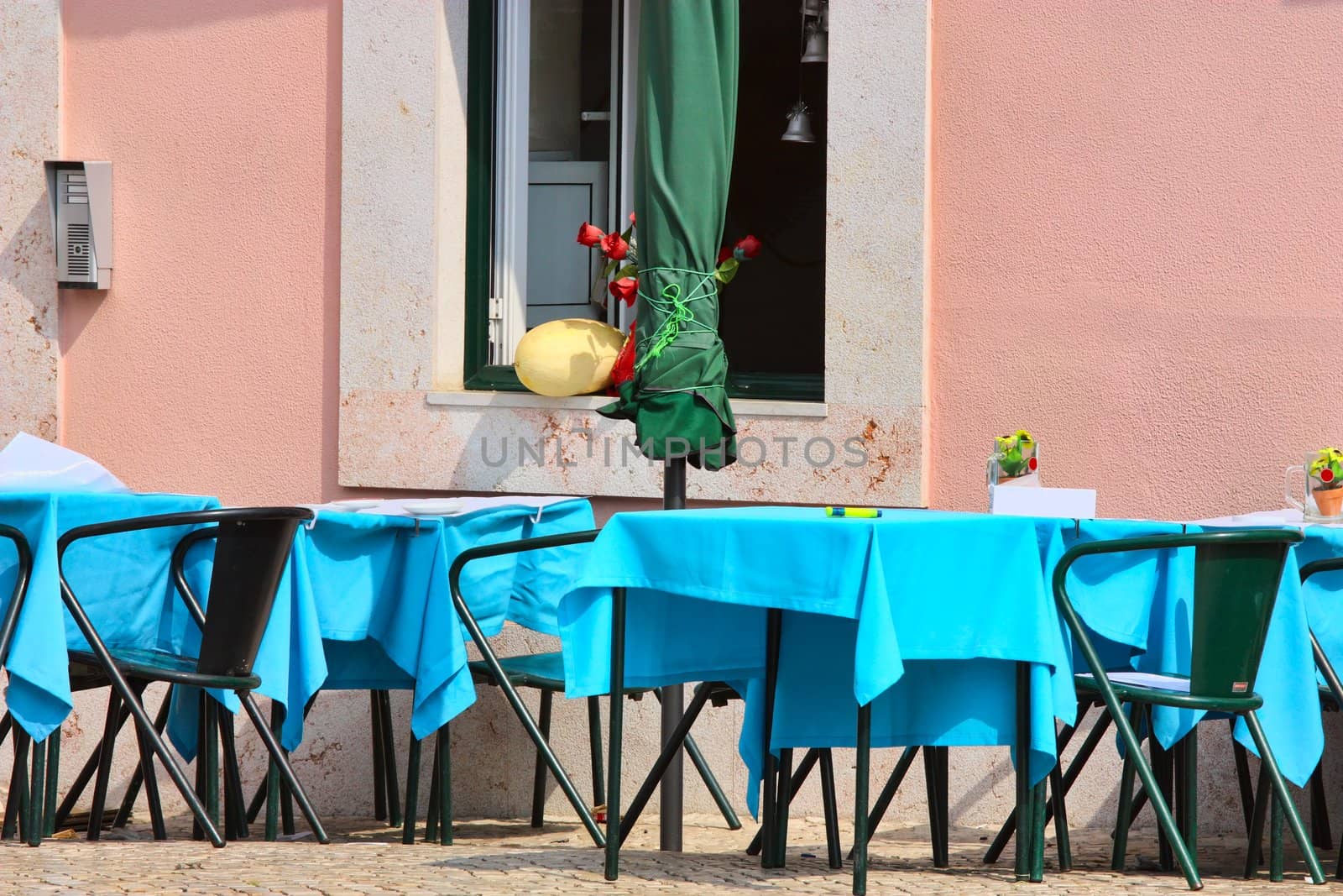 empty tables in street cafe