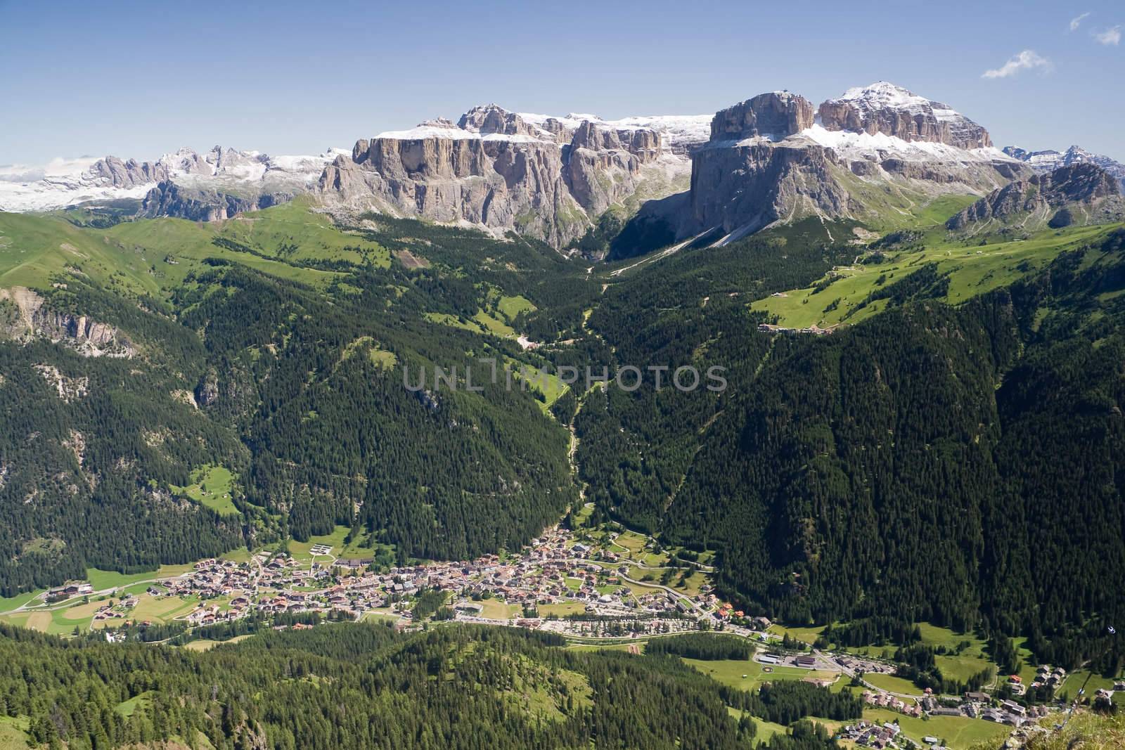 Aerial view of Canazei and Fassa valley with Saas Pordoi mount (Sella group), Pordoi pass and Sella pass